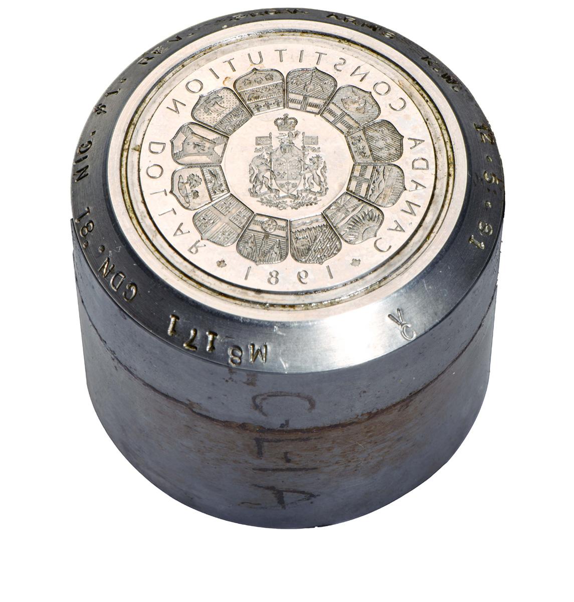 Steel cylinder with a reversed coin design of the Canadian and provincial coats of arms.