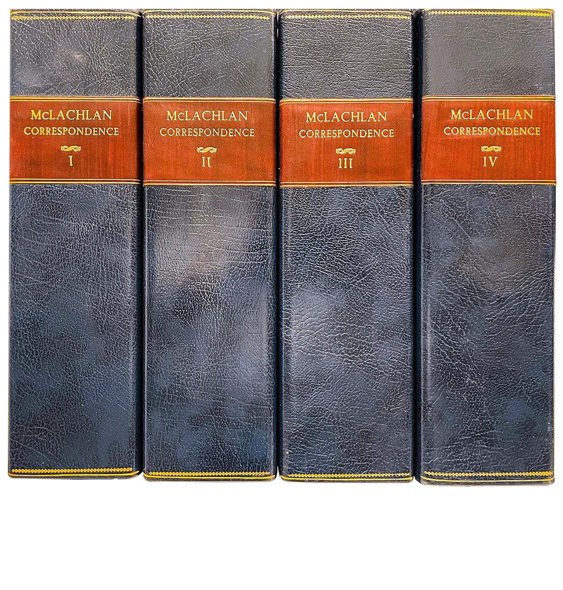 Row of cardboard cases, book-like, each of faded blue fabric with red horizontal stripe carrying gold lettering.