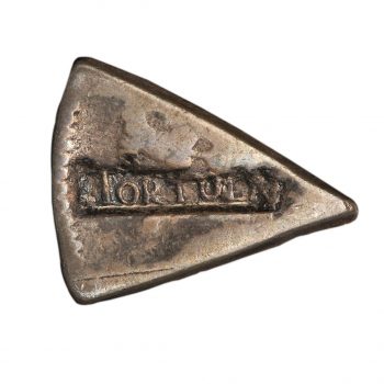 Wedge-shaped section of a coin with the word Tortola stamped on it.